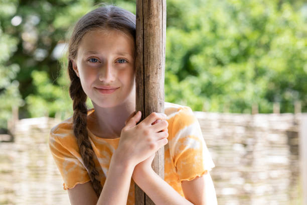 Young girl standing near the column