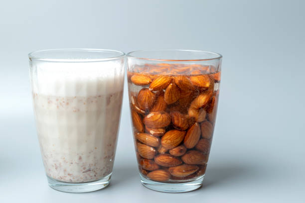 istock Side view of glasses with almonds nuts and almonds nuts milk. 1412694003