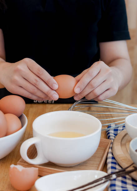istock Man in the kitchen cooking a dough. Hands breaks an egg into a bowl ,hands pouring bitten egg ,Baking concept 1412694746