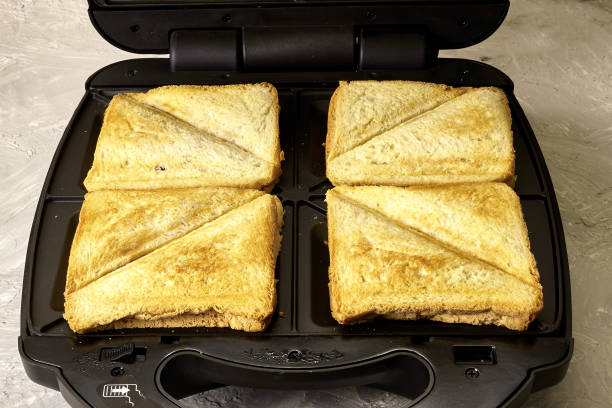 istock freshly baked delicious sandwiches in a sandwich maker 1412695903