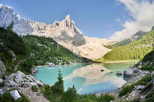 Stunning view of Lake Sorapis with its turquoise waters and surrounded by beautiful rocky mountains. Lake Sorapis is one of the most beautiful excursions in the Dolomites, Italy.