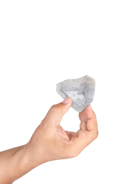 istock Hand holding natural diamond isolated on white background 1412696375