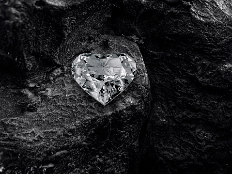 Heart shaped diamond on black coal background