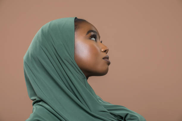 istock Beautiful Muslim Woman wearing hijab in a studio shot 1412696708