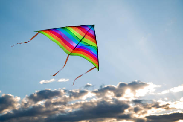 istock A kite flies in the sky with clouds, clouds and sun rays 1412697449