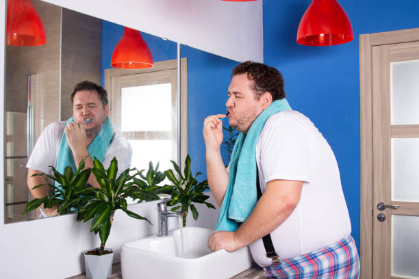 istock Funny fat man in the bathroom. 1412697469