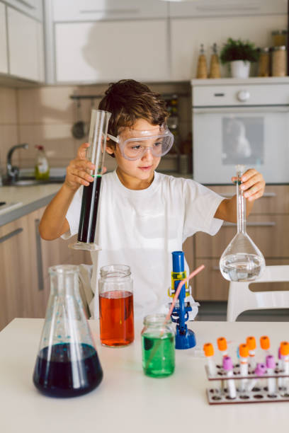istock School boy playing experiments in the kitchen 1412699918