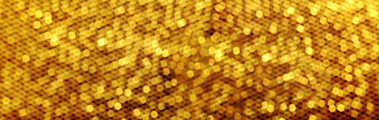 Blurry background image of defocused golden color abstract lights pattern