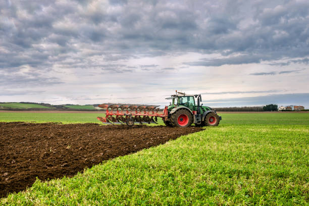 istock Farmer working in the fields with a pedestal plough in autumn 1412701708