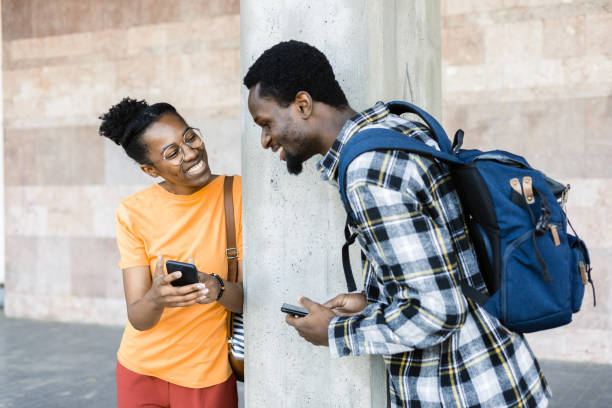 istock African couple having fun together and using smartphones 1412703912