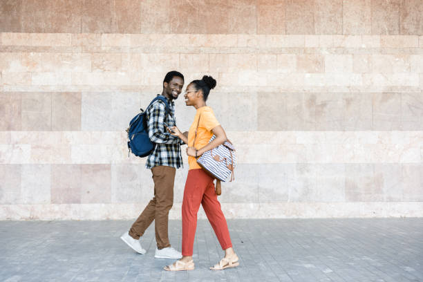 istock Happy African couple using smartphones and having fun 1412703917