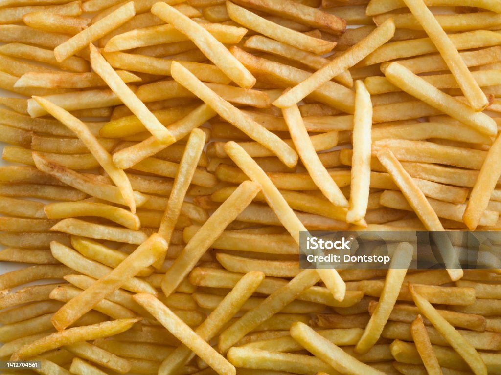 French fries background French fries on a wooden plate. Unhealthy Eating Stock Photo