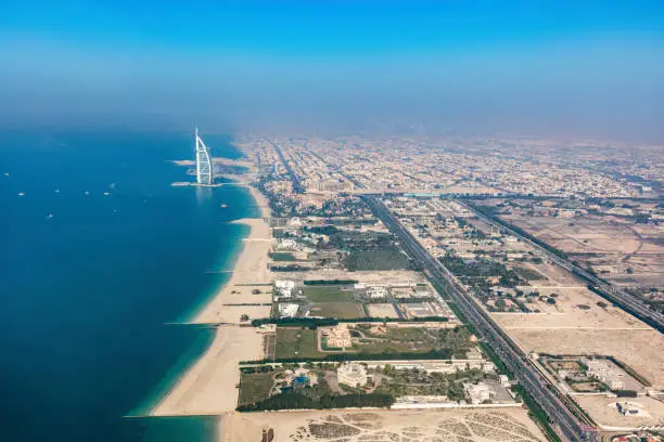 Burj Al Arab hotel in Dubai UAE aerial view from helicopter at sunset