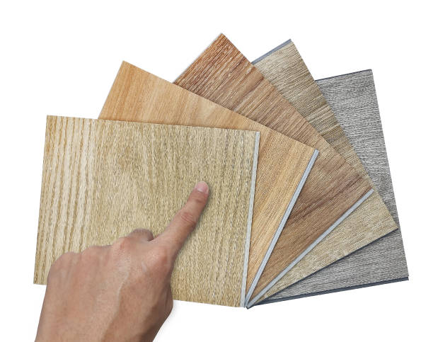 istock architect's hand selecting modern vinyl flooring tile collection. stack of samples of vinyl sheet catalog in multi color and texture for customer selection. isolated on background with clipping path. 1412707008
