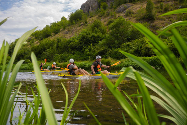 istock Group of friends kayaking in pairs 1412707614