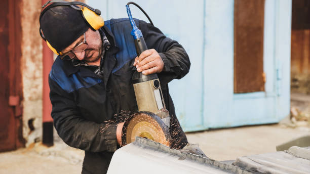 istock Worker saws metal with an old angle grinder. Selective focus. Outdoors. Flying sparks. Industrial concept 1412710153