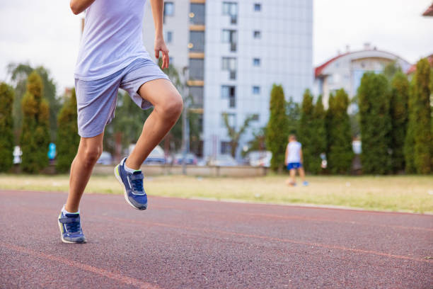 istock Kid running on the track. Only legs. 1412710510