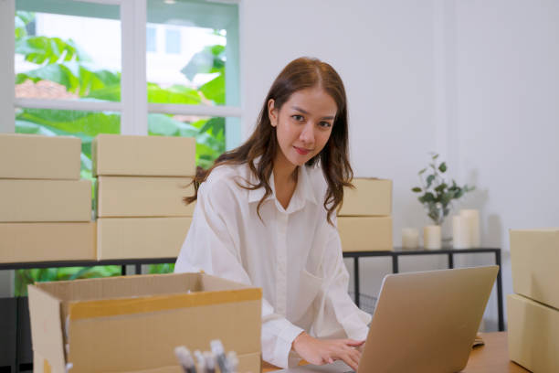istock Young entrepreneur is packing item. 1412712763