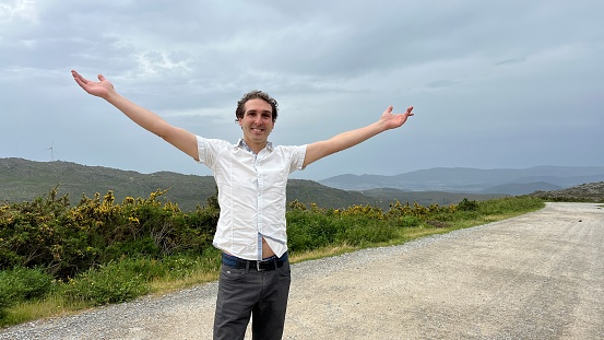 a man of European appearance points to the sky in all directions here you can put a text First he raises his hands to the right then looks to the left and is very happy. High quality 4k footage