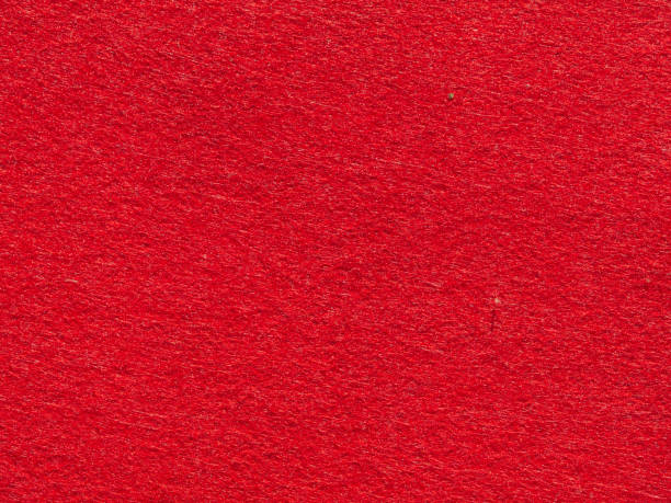 istock Bright red textured background surface. Close-up of synthetic felt fabric in red 1412713048