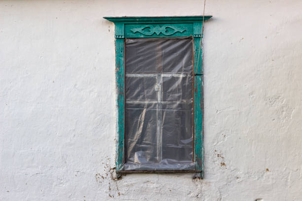 old wooden window on a clay wall