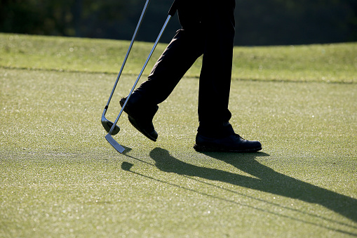 A focus scene on golfer walking at golf course in Malaysia.