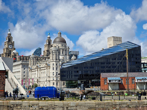 Liverpool, United Kingdom - May 31, 2022: Modern and classic architecture and strolling people at the Liverpool Docks, Port of Liverpool
