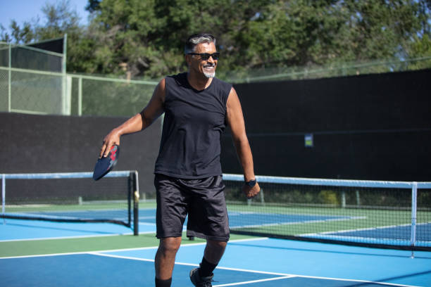 istock Athletic Man in 60s Playing Pickleball 1412715382