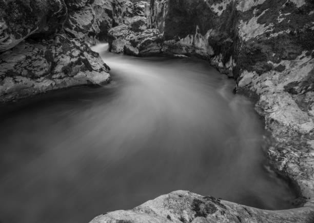 Black and white water in Soca river in summer hot evening in Slovenia stock photo