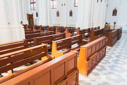 People pray in the church. Church parish. Believers sit on benches in the hall. Prayer time.