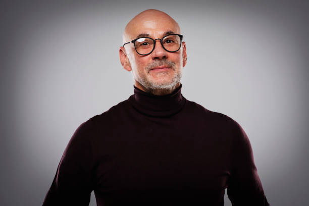 istock Smiling middle aged man wearing casual clothes while standing at isolated background 1412718474