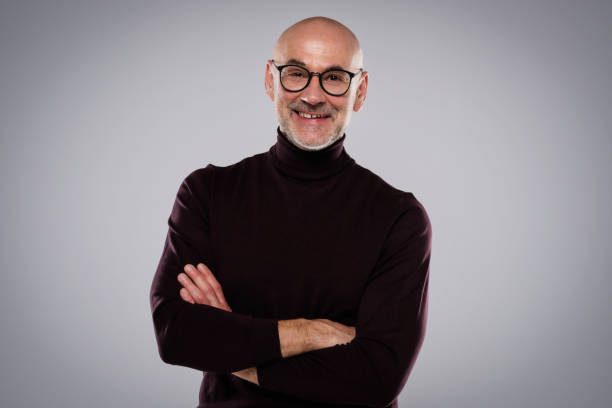 istock Smiling middle aged man wearing casual clothes while standing at isolated background 1412718486
