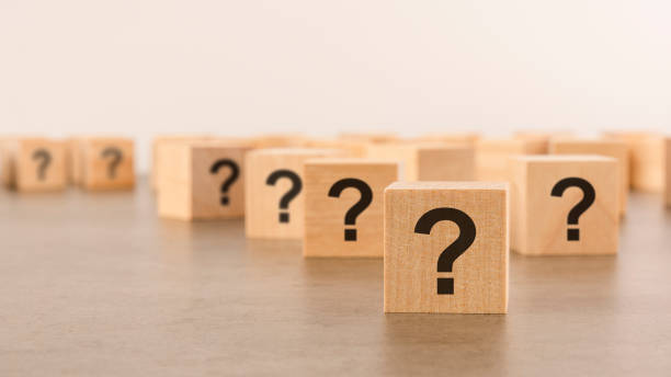 istock front view on many wood cubes with question marks. many question arising concept 1412720020