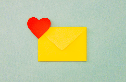Red heart shape on the yellow envelope.
