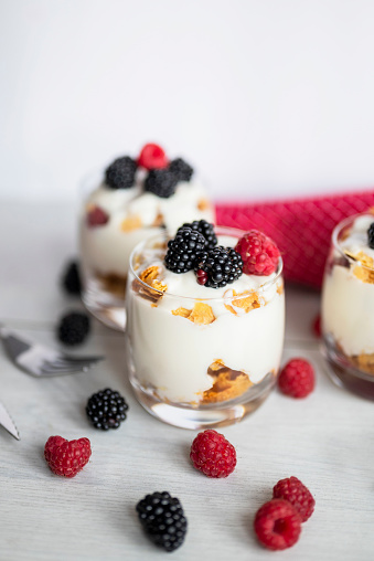 delicious creamy dessert with cream and raspberries and blackberries in a glass