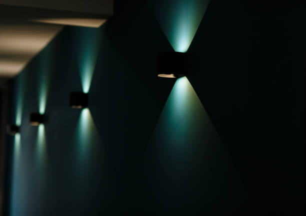 Modern wall lamps is lighting on the dark green wall. backlit, night decorative lamp