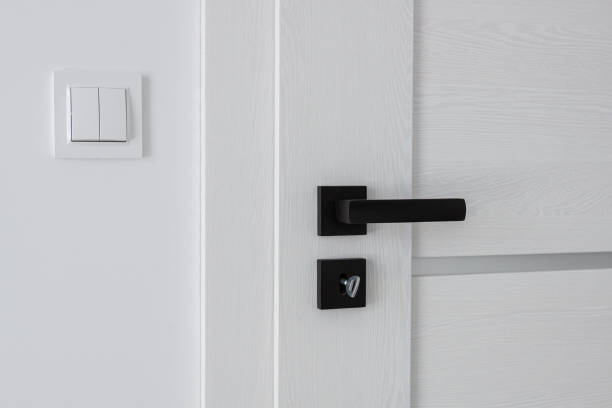 istock A white wooden door with a black metal handle. 1412727356