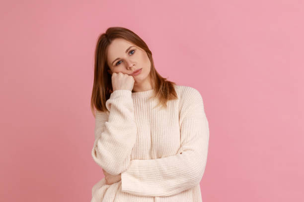 istock Woman leaning on hand and expressing disinterest apathy with dull look, feeling lazy indifferent. 1412728962