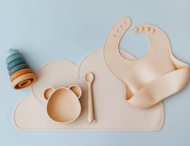 istock Silicone dishware on light background. Serving baby, first feeding concept. Kids tableware. Flat lay, copy space, top view 1412729611