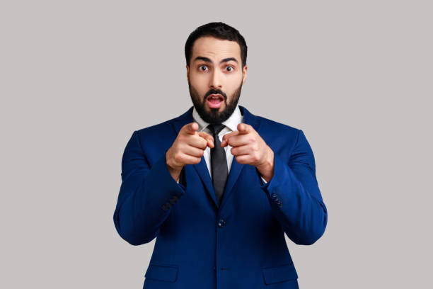 istock Man pointing to camera, standing with surprised shocked expression on face, hard to believe. 1412729673