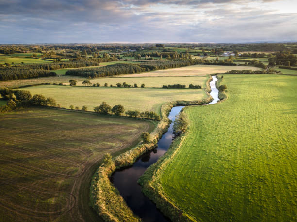 Aerial view of River Maine in County Antrim, Northern Ireland, in summer A beautiful aerial scenic of the County Antrim countryside, in summer, with agricultural land and grass in fields, and River Maine winding into the distance. taken at Glarryford, Northern Ireland northern ireland photos stock pictures, royalty-free photos & images