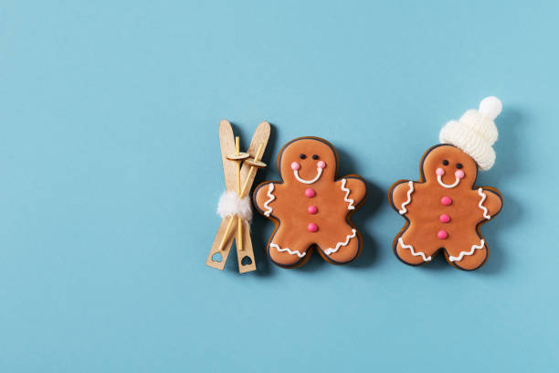 istock Two gingerbrads men on stick on blue background 1412730002
