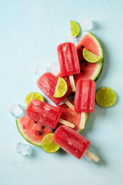istock Ice cream popsicle watermelon with ice cube and lime on blue background 1412730014