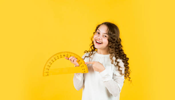 istock Excited about knowledge. mathematics and people concept. geometric shapes. modern education concept. girl with protractor and triangle ruler. back to school. STEM school disciplines. copy space 1412731721