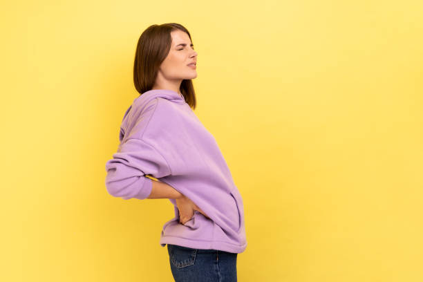 istock Frustrated anxious woman holding hands on lower back, kidney injury, backache. 1412732916