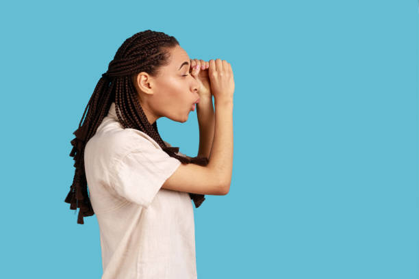 istock Astonished woman making glasses shape, looking through binoculars gesture with surprised expression. 1412733008