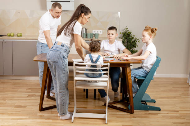 istock Toddier playing at the kitchen table, coloring book and crayons 1412734301