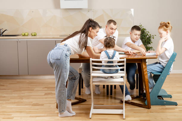 istock Toddier playing at the kitchen table, coloring book and crayons 1412735441