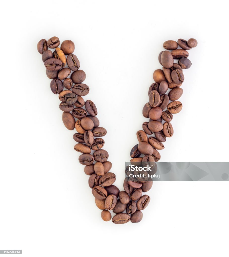 Capital letter V made from coffee beans Capital letter V made from coffee beans. Coffee font. Alphabet made from coffee beans. White background. Roasted coffee beans. Agriculture Stock Photo