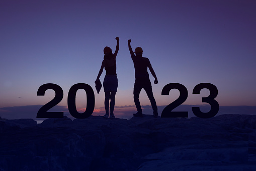 Silhouette of a woman and man worker while celebrating new year 2023